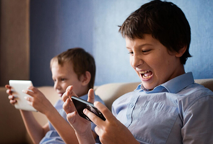 Primary school age kid playing mobile game